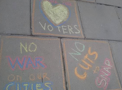 Messages in Chalk: No War on Our Cities, No Cuts to SNAP, Love Voters